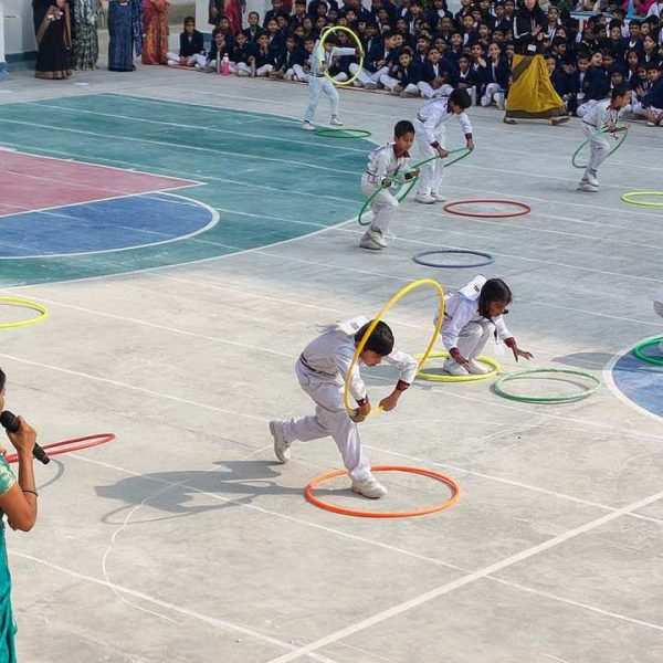Kids participate in fun hula hoop exercises during school event at Gurukul Montessori School.
